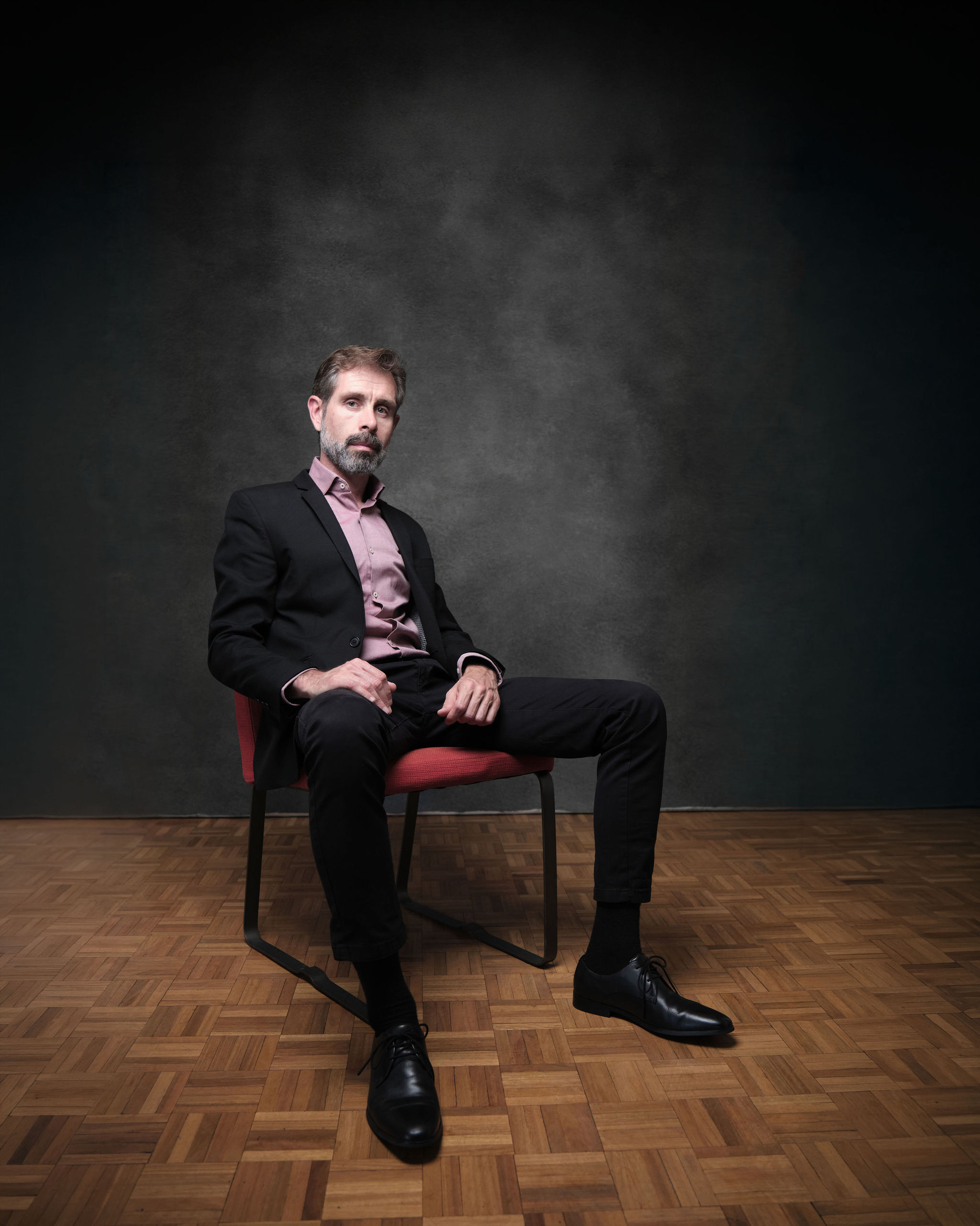 Iago Cabrero actor — Dramatic Lead, full length seated portrait, red chair
